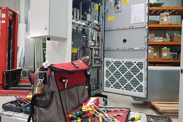 Inverter Technical Advice picture shows an enginners tools and an inverter in a cabinet