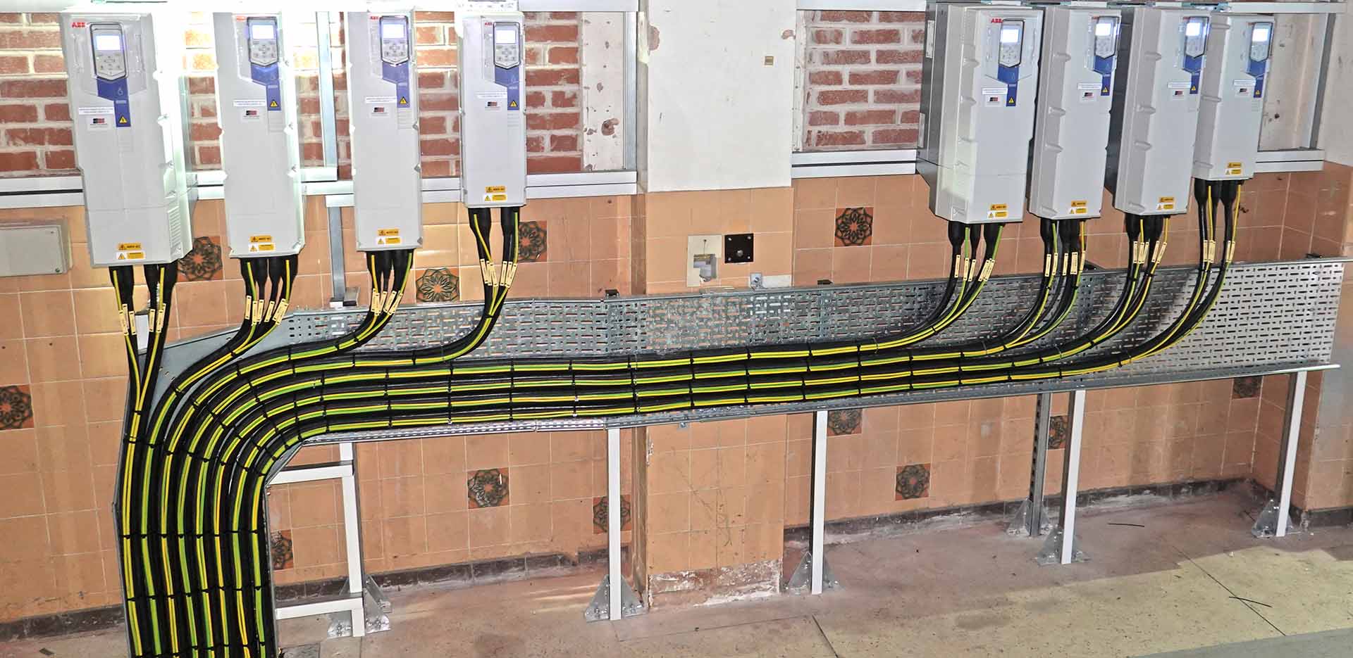How Do Variable Speed Drives Reduce Energy Consumption? this image shows a bank of variable speed drives set up at one of our client premises